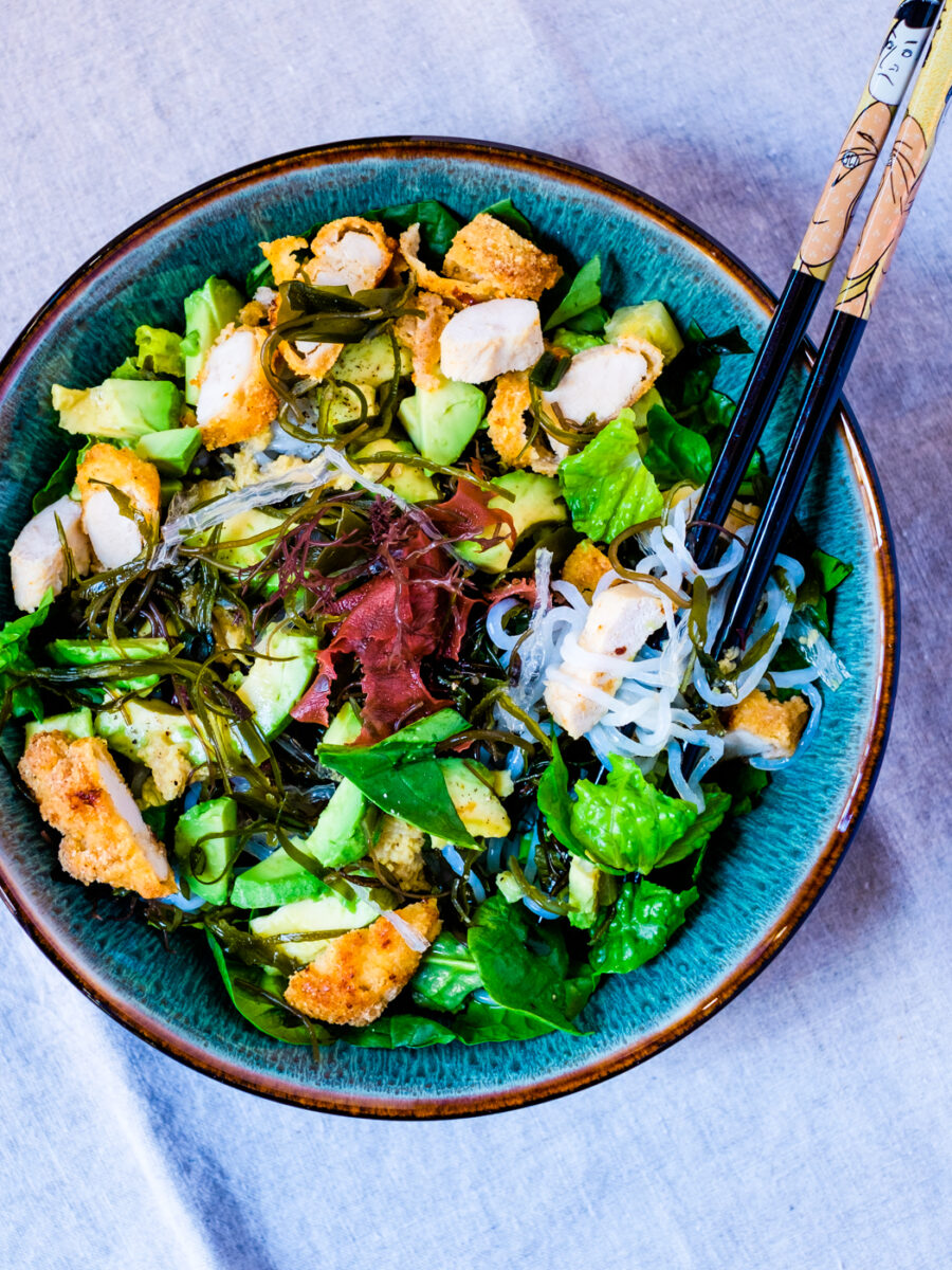 Sea vegetables chicken salad in a bowl with chopsticks