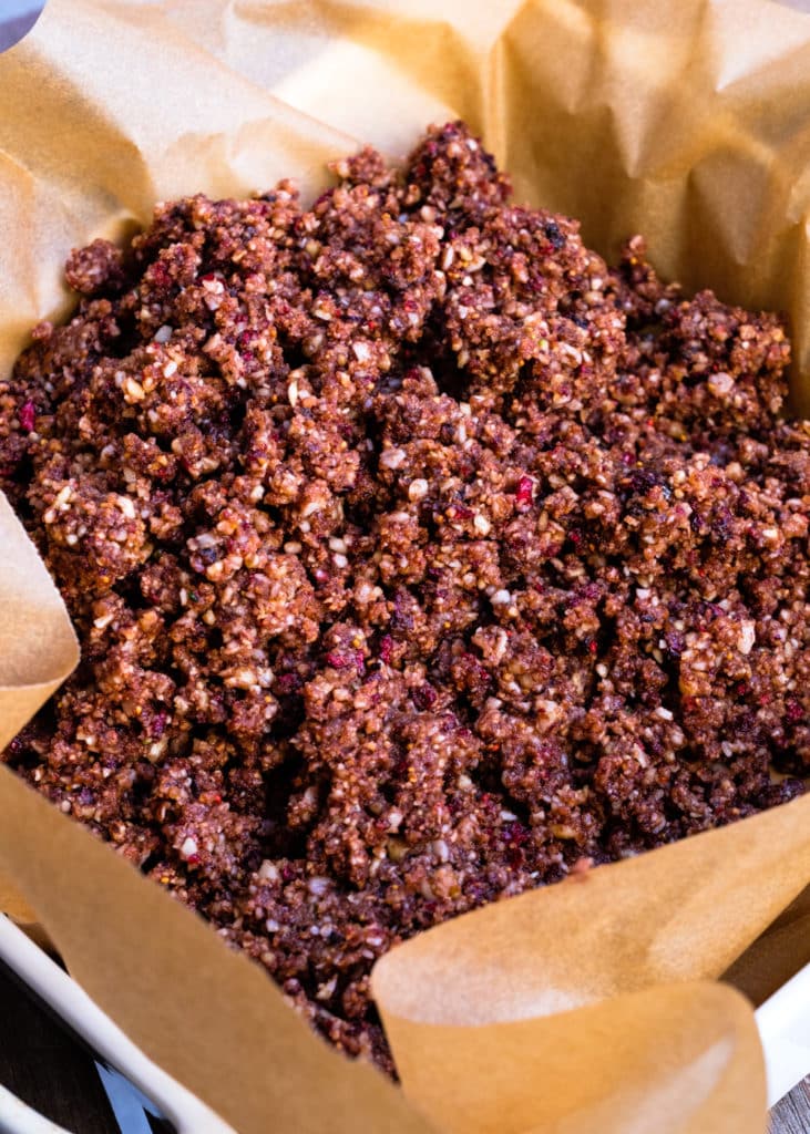 The ingredients have been processed in a food processor and transferred to a parchment-lined baking pan.