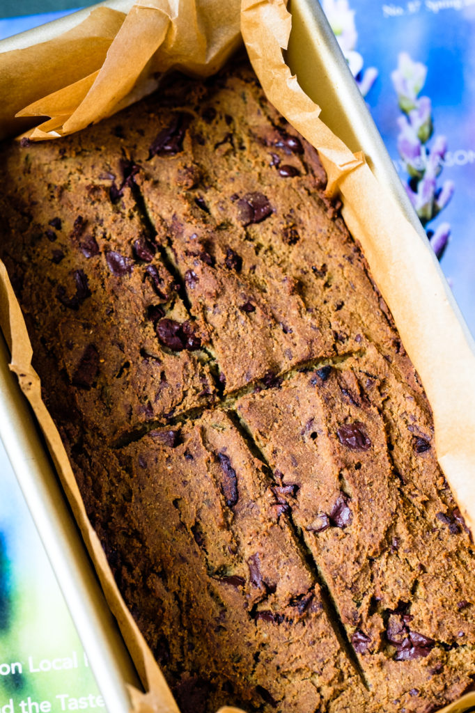 The baked bread in the parchment-lined loaf pan.