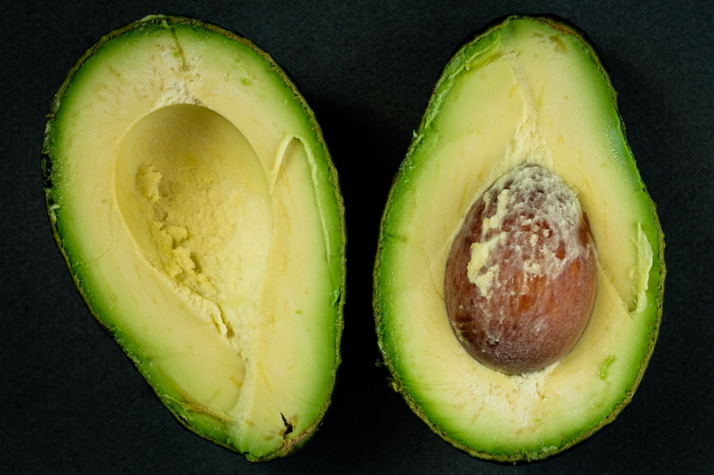 An avocado split in two halfs