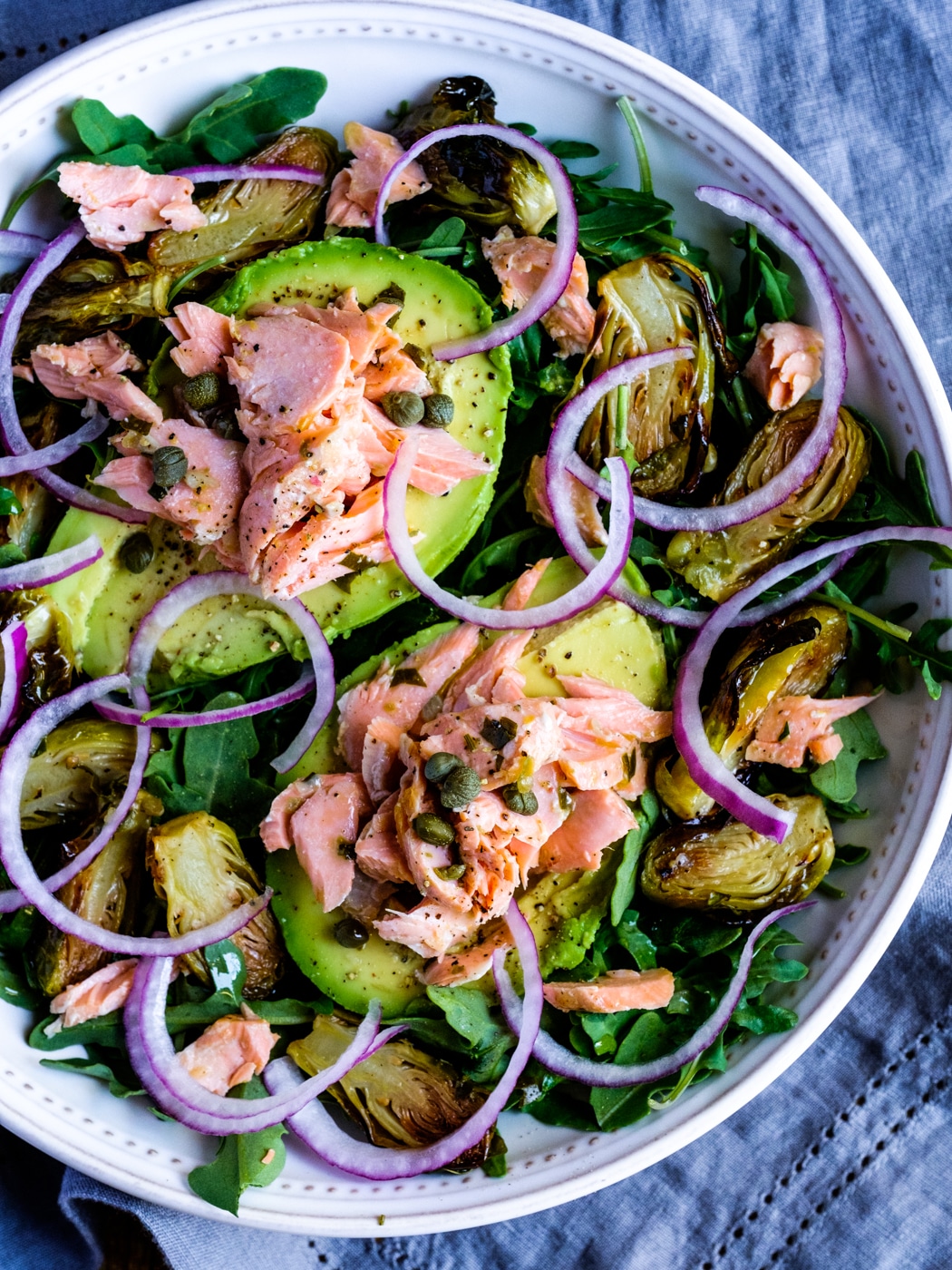 Avocado and salmon boats with arugula and broccolini