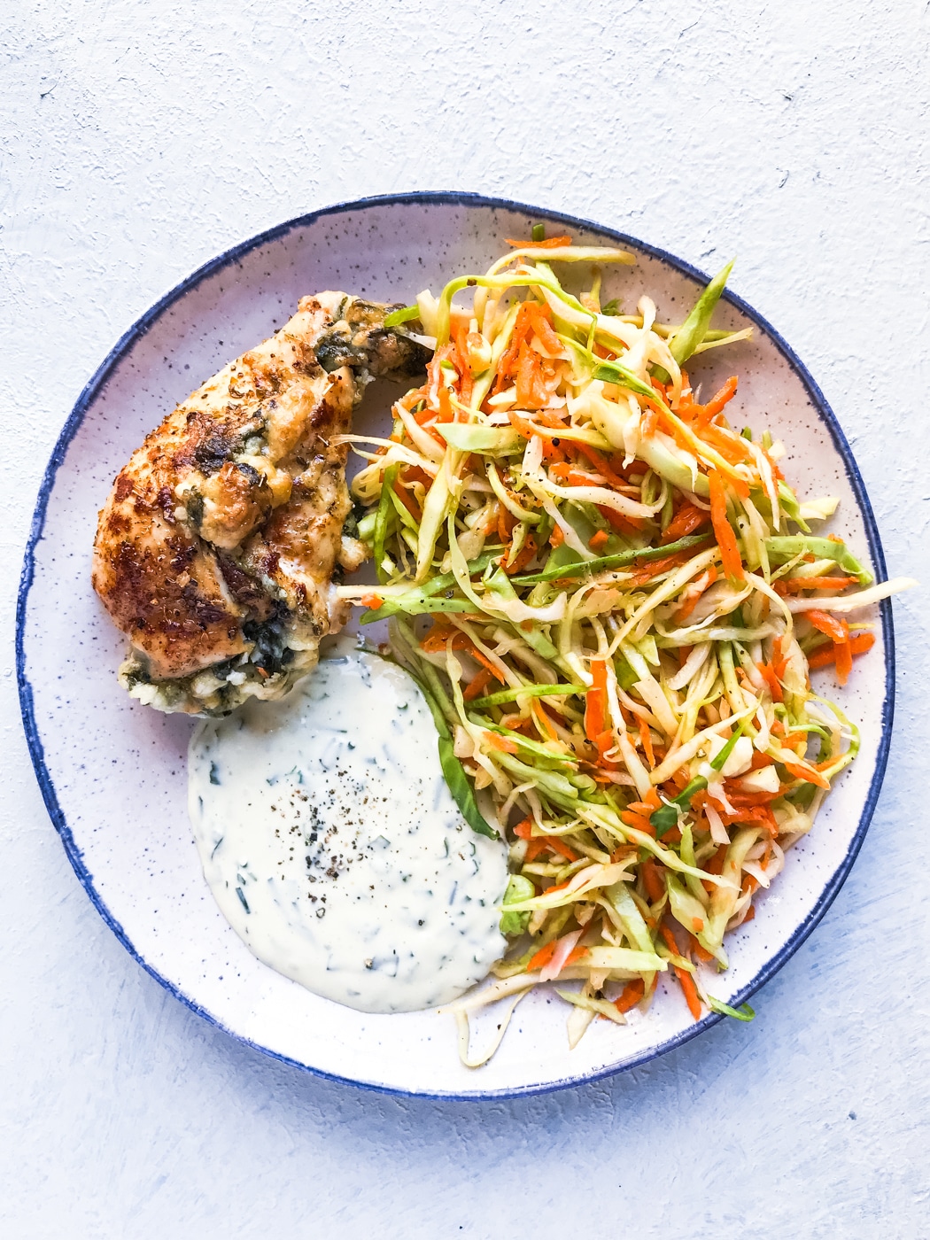 Spinach stuffed chicken breast with a salad side dish