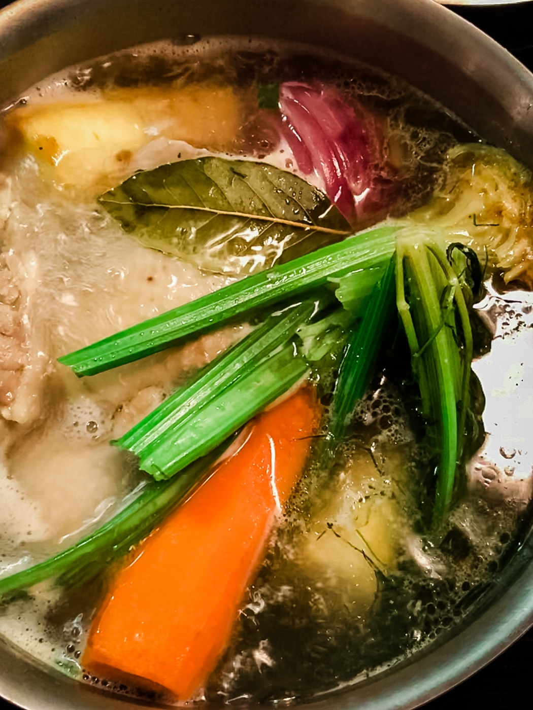 Cooking chicken stock for the creamy mushroom chicken dish