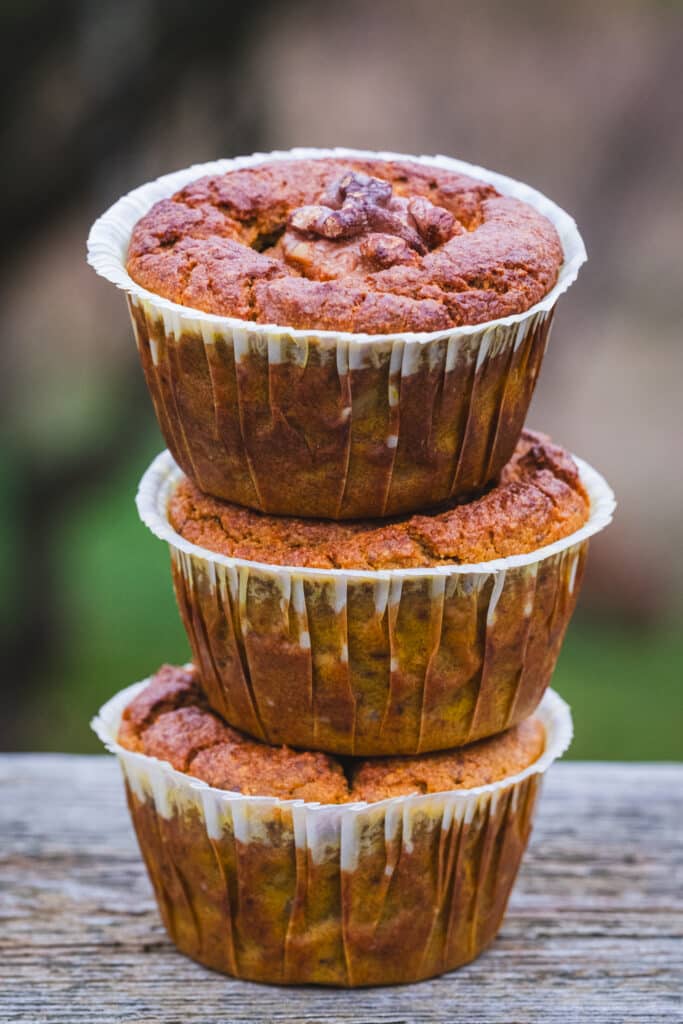 Three stacked ginger turmeric sweet potato muffins