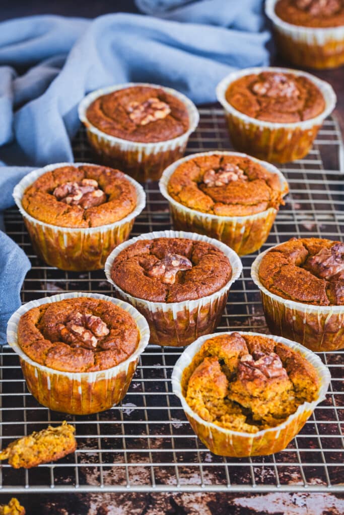 Freshly baked muffins arranged on a cooling rack.