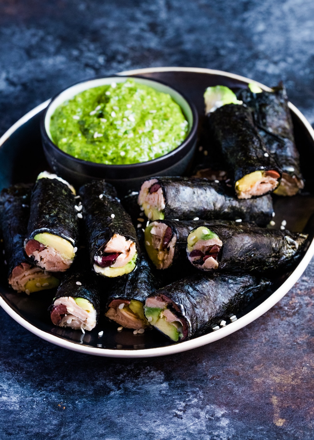 Nori wraps with salmon, avocado and green sauce