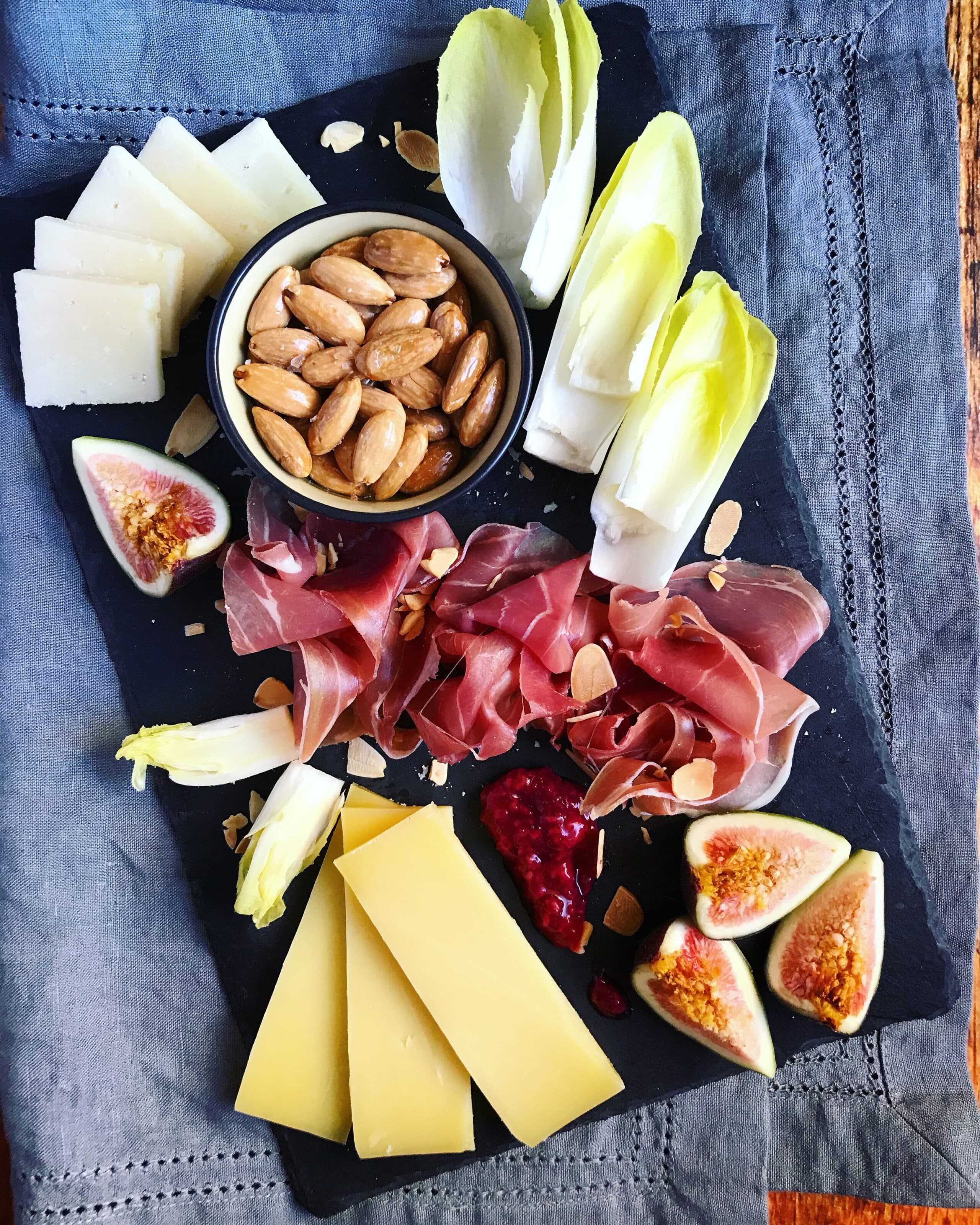 A charcuterie board and roasted almonds