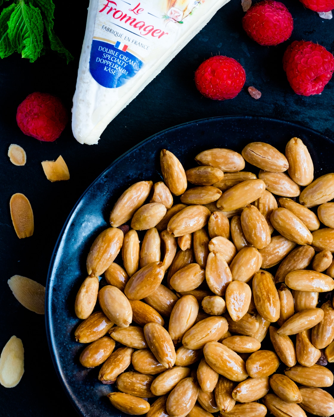 Roasted almond in a small bowl and a creme cheese