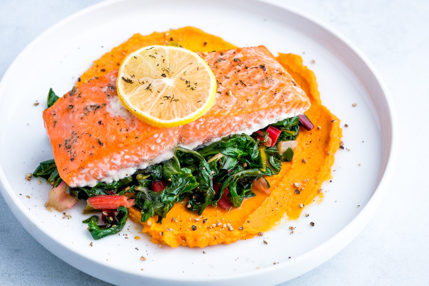 Sweet potato hummus served as a base for this dinner with salmon and Swiss chard.