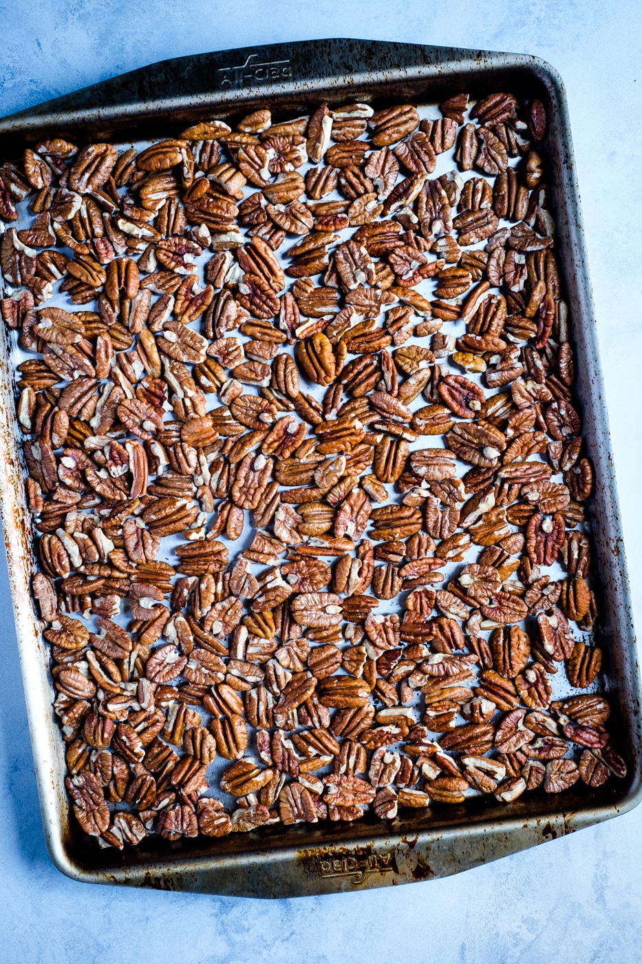 Roasted pecans on a baking sheet