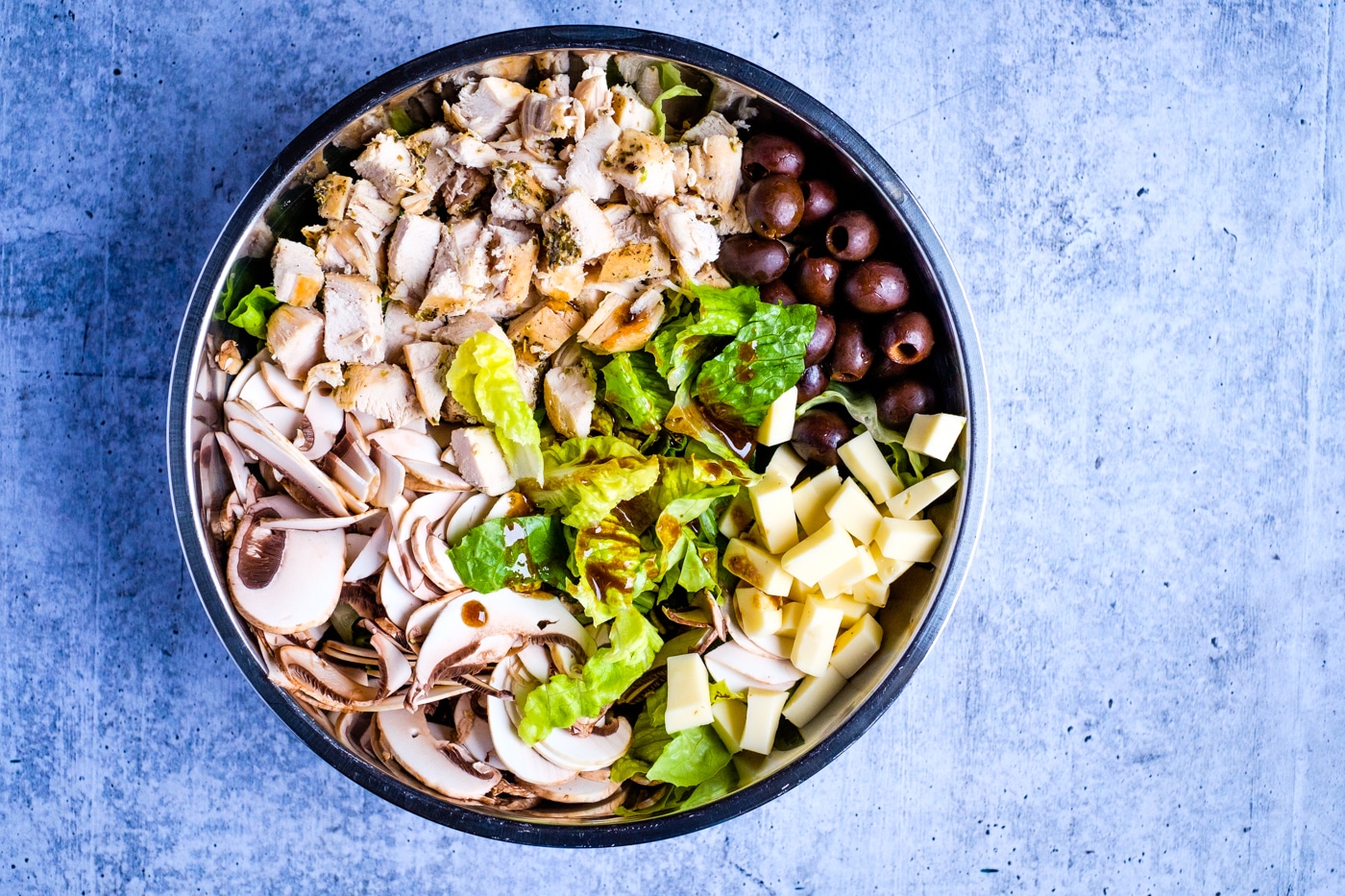 All the ingredients for an Italian chicken salad in a bowl