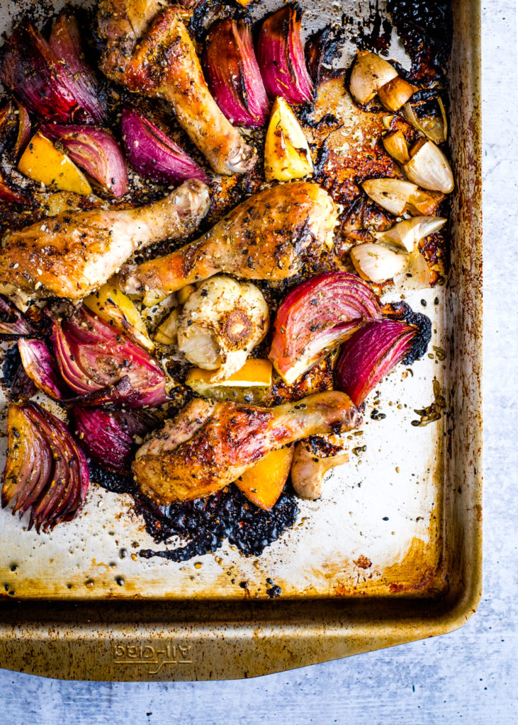 Drumsticks in a baking sheet. They have been rubbed with the za'atar spice blend.