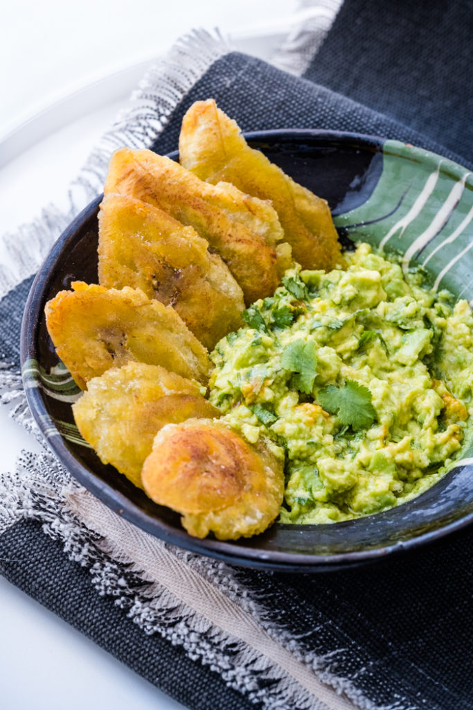 Guacamole with tostones on a plate