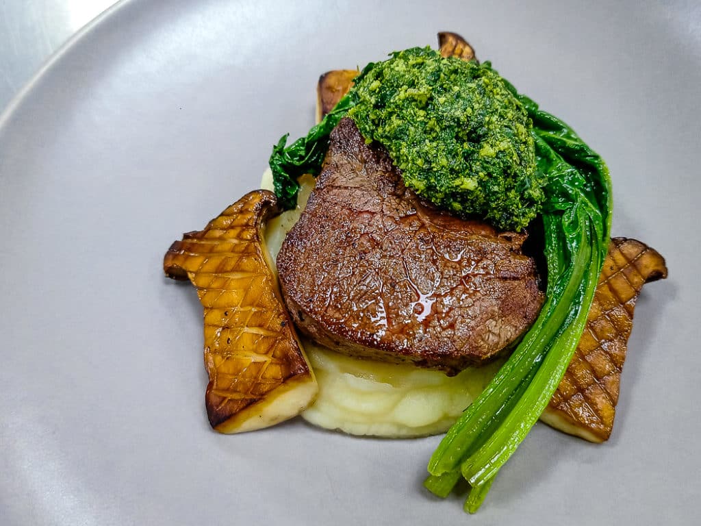 Grass-Fed Beef Tenderloin steak served with Celeriac Puree, Chard, King Oyster Mushroom, Kale and Macadamia Pesto