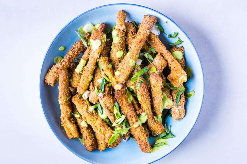 The finished baked zucchini fries on a plate and ready to be served