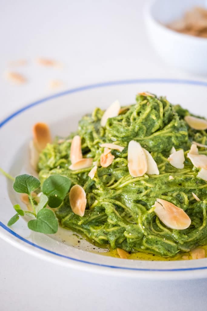 Green pasta sauce with nettles and garlic on a plate