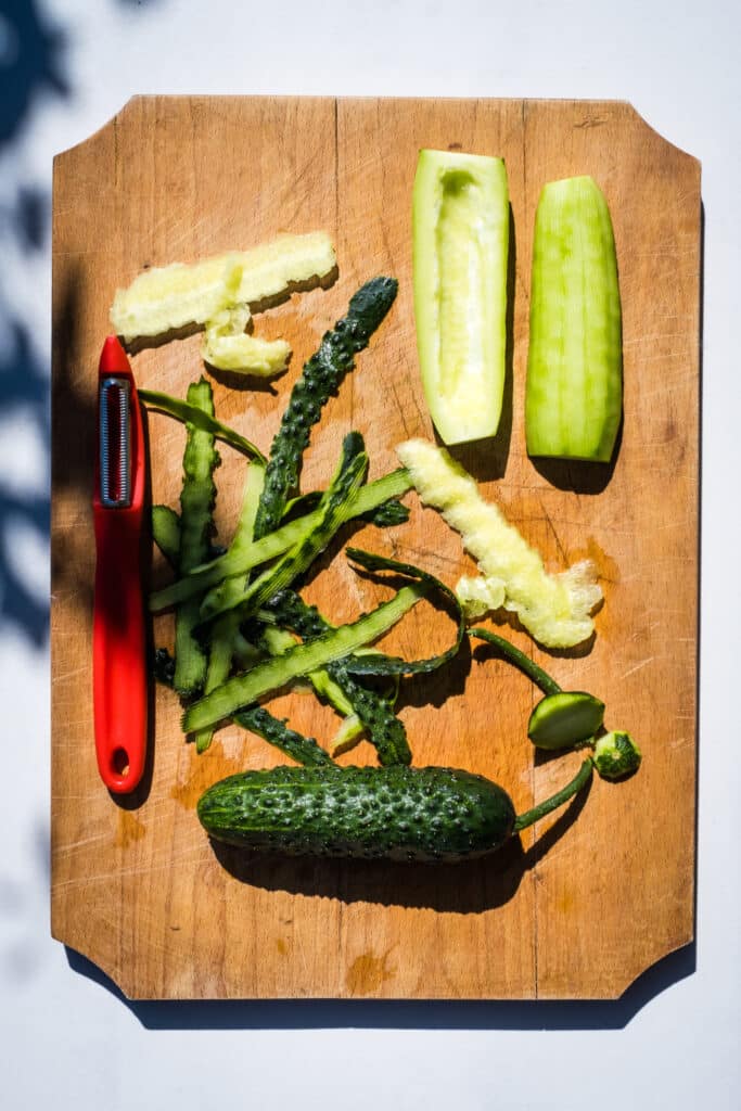 Cucumbers on a cutting board. The peels and seeds have been removed.