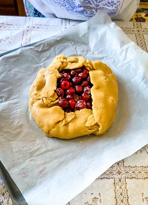 The folded gluten free cherry galette ready to be baked in the oven