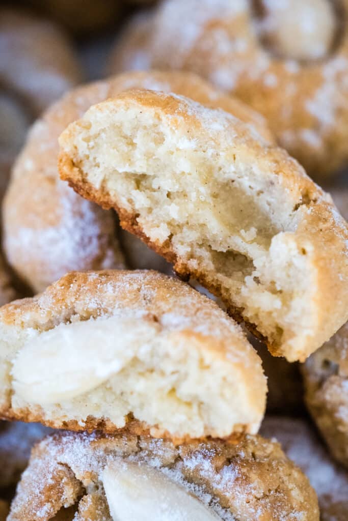 An almond thumbprint cookie, split in half to reveal its texture.