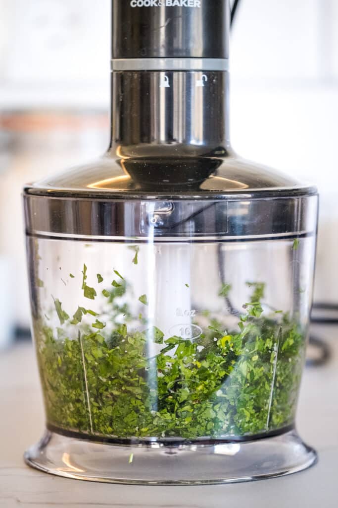 The ingredients for the parsley and chives chimichurri in the blender