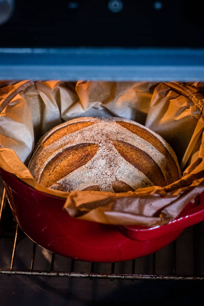 The gluten free sourdough bread in the oven. It is baked in a cast iron pot.