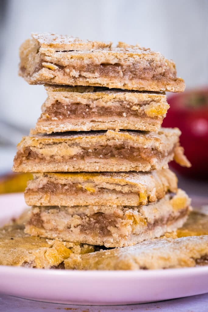 Stacked apple pie bars on a plate