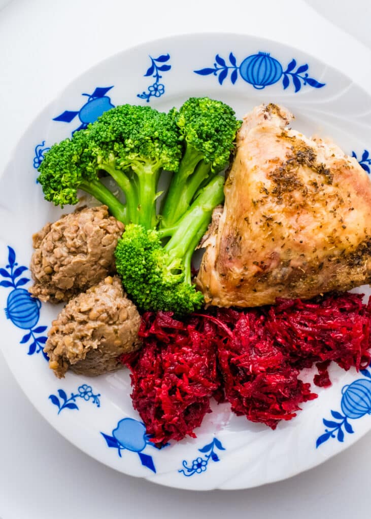 Beetroot and horseradish salad with lentil hummus, broccoli, and baked chicken