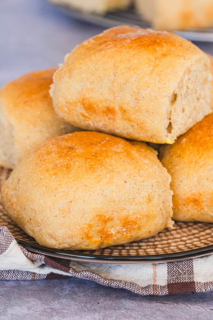 Freshly baked gluten-free sourdough rolls arranged on a plate.
