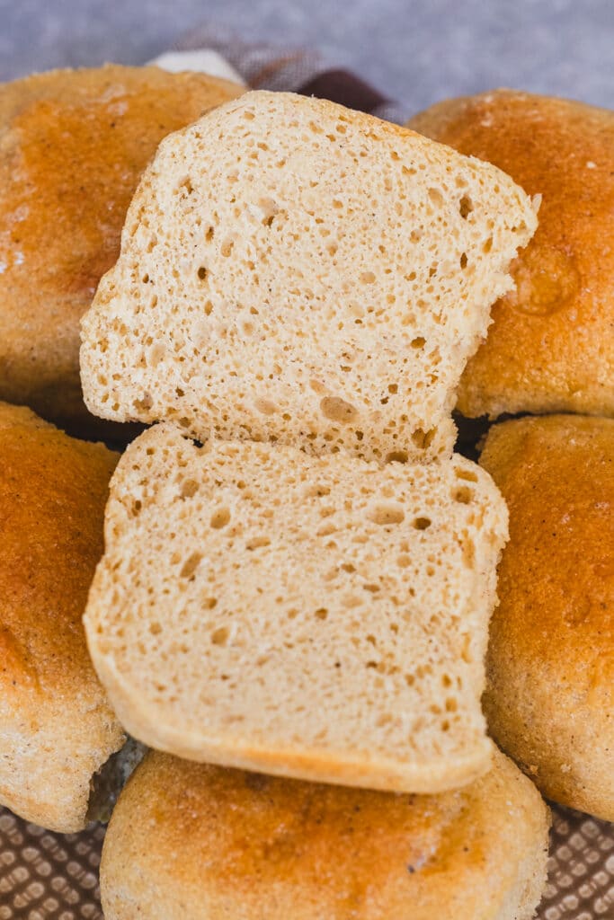 A sliced gluten free sourdough roll. The texture looks soft and pillowy.