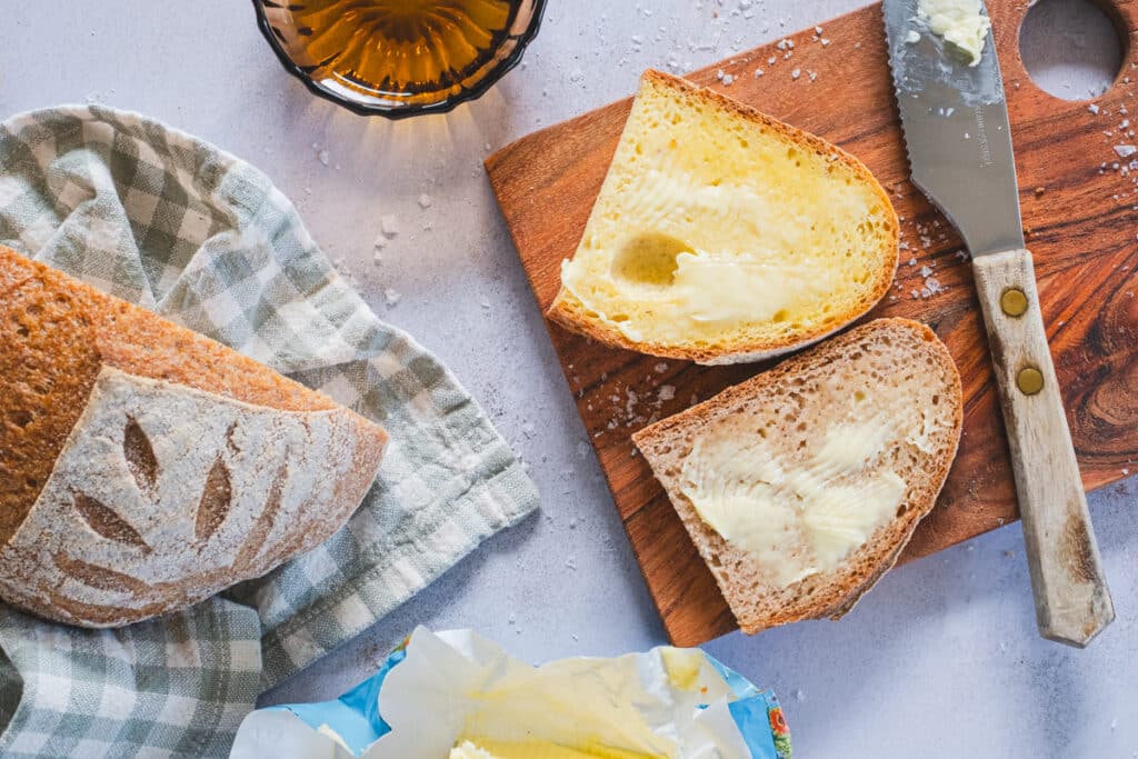 two toasted and buttered slices of gluten-free sourdough: millet (top) and sorghum (bottom)