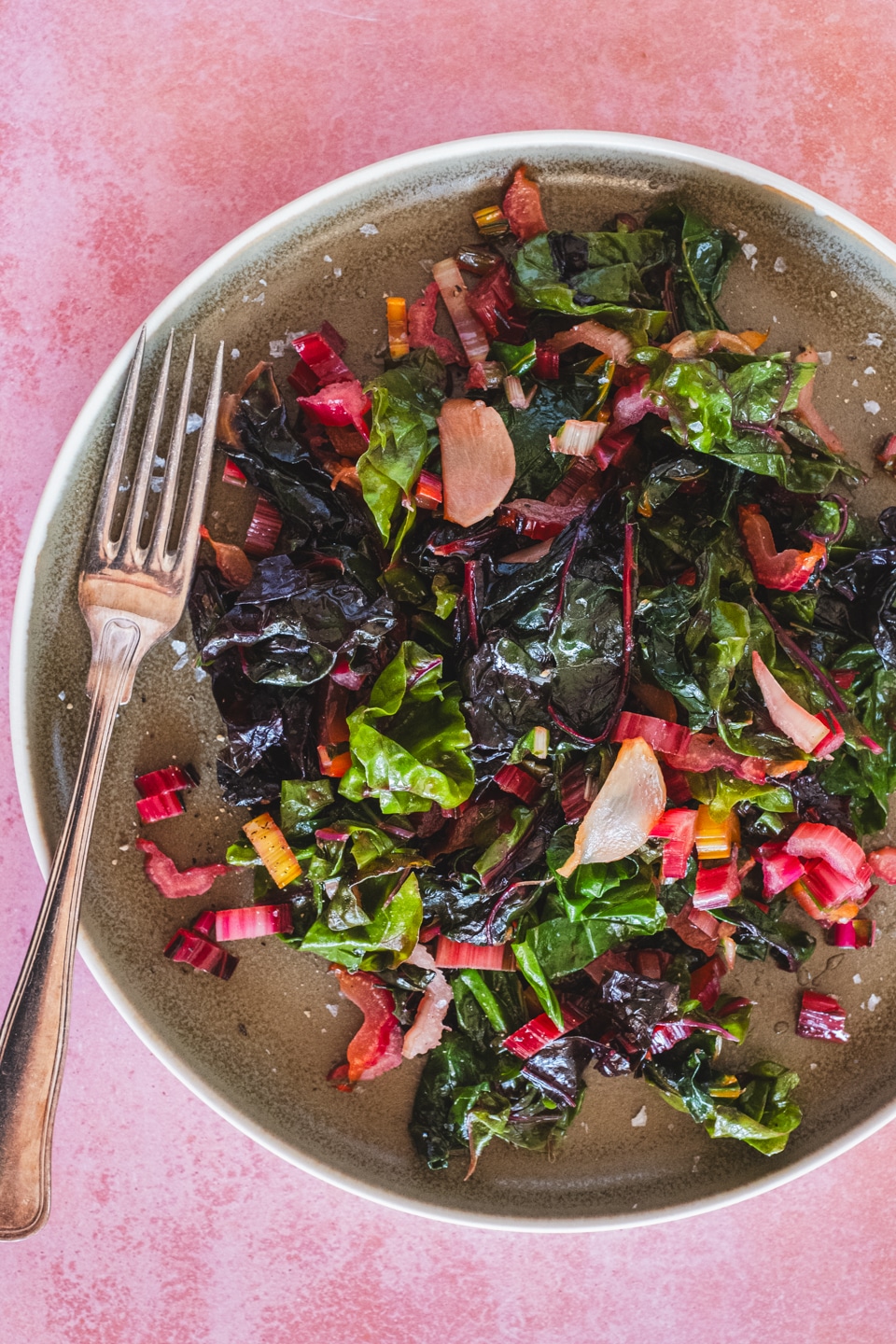sauteed rainbow swiss chard on a serving plate and a fork