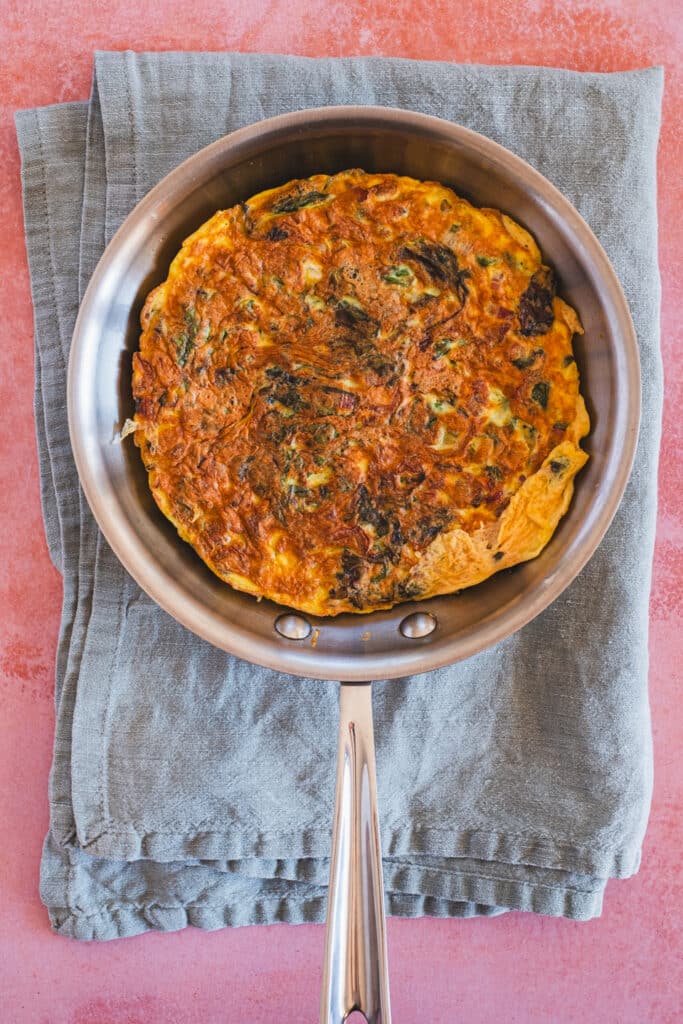 The frittata has been successfully flipped in the skillet.
