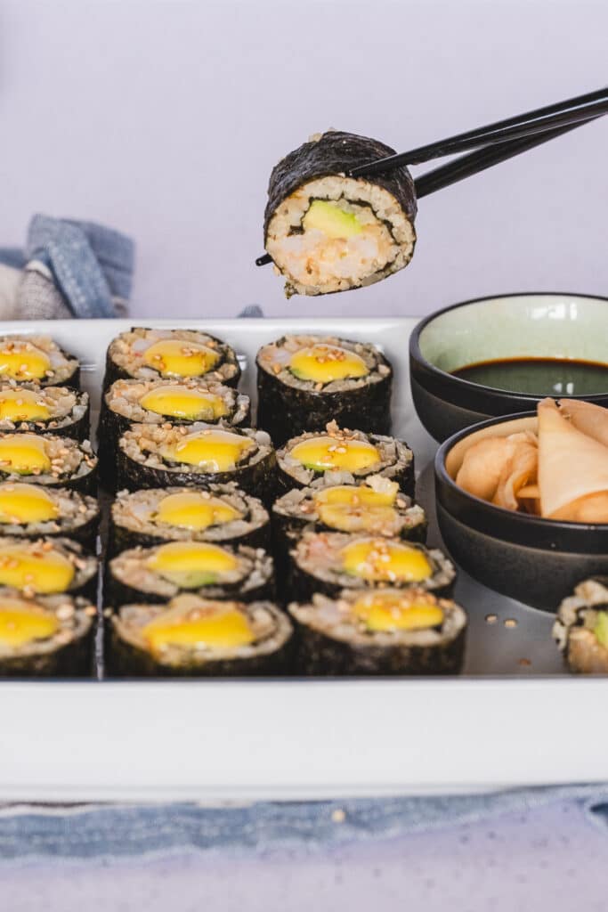 Sushi rolls topped with spicy mayonnaise and served with coconut aminos and pickled ginger.