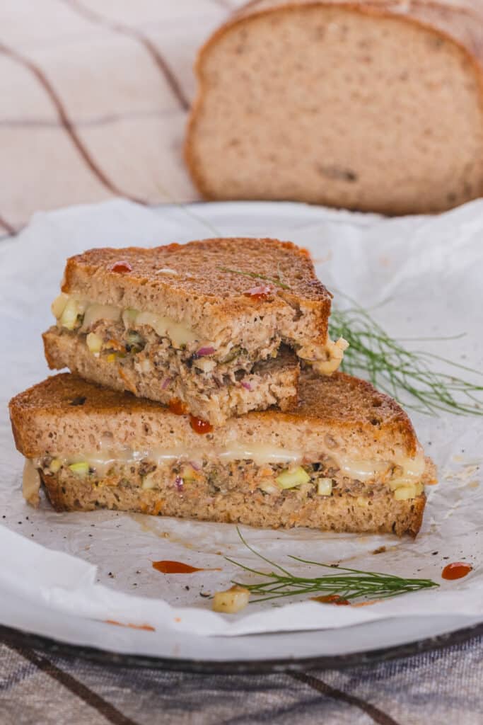 a sardine melt sandwich, sliced in half, stacked