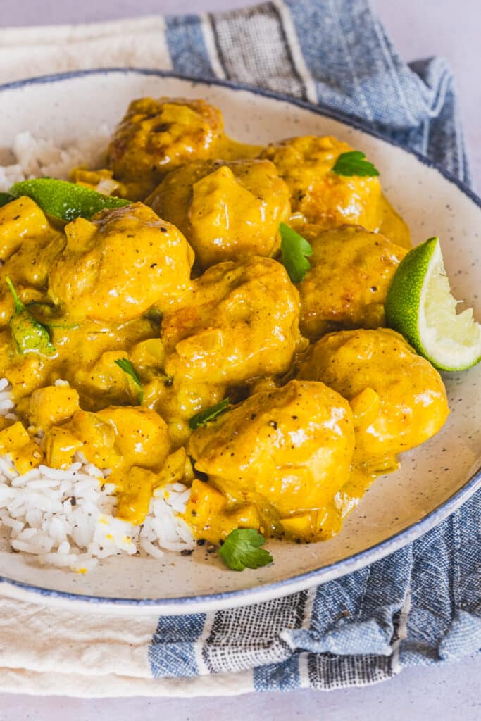 Coconut curry chicken meatballs served on a plate.