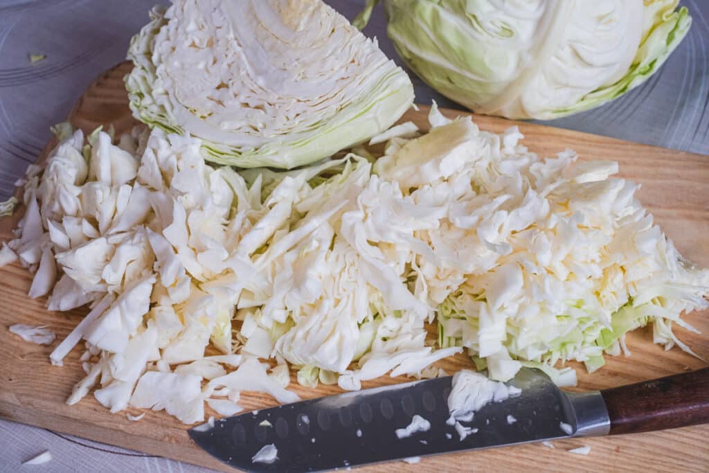 Shredded cabbage on a cutting board.