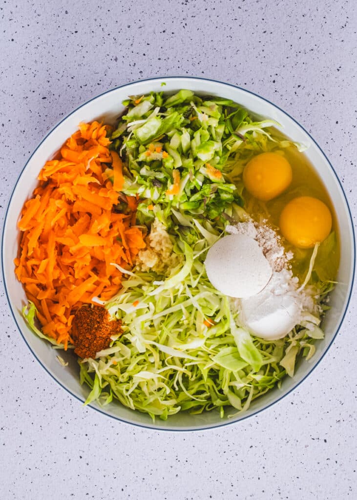 All the ingredients for the cabbage pancakes in a mixing bowl.