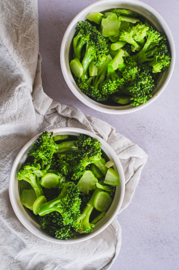 Two ramekins filled with broccoli florets