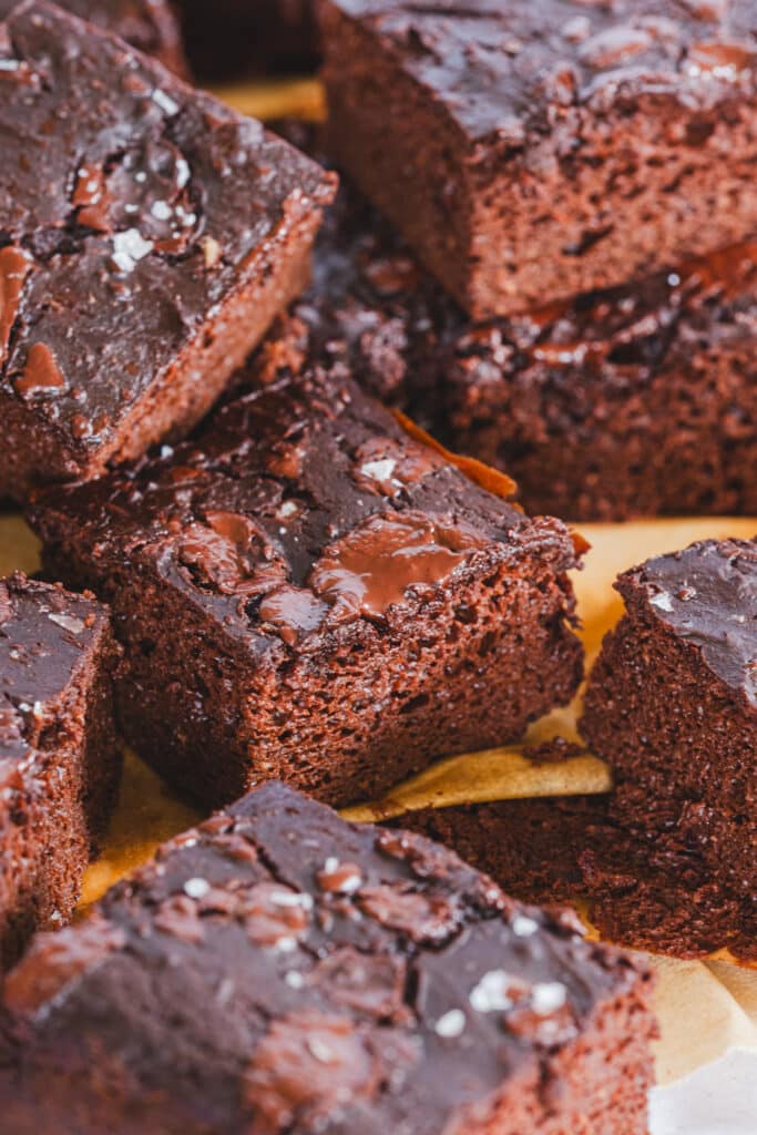 Close-up of brownies displaying their texture with visible pools of melted chocolate.