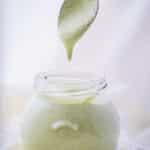 Dairy free ranch dressing in a jar, running from a spoon