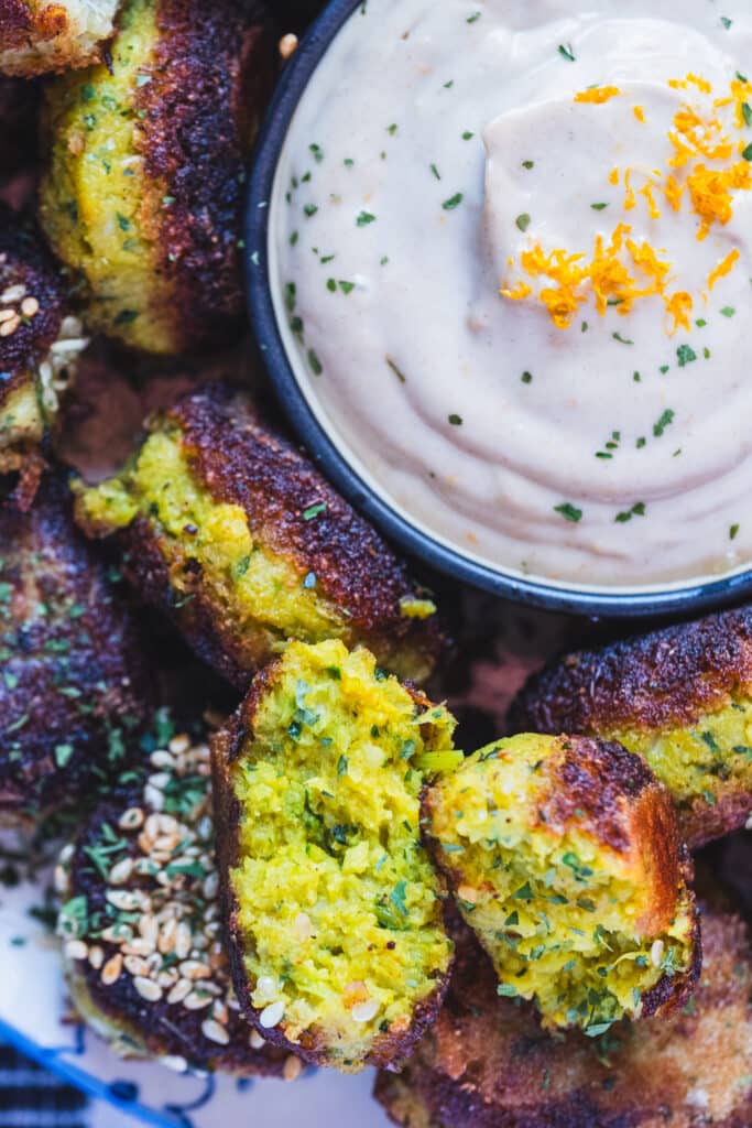 chickpea free cauliflower falafel on a plate, with tahini sauce