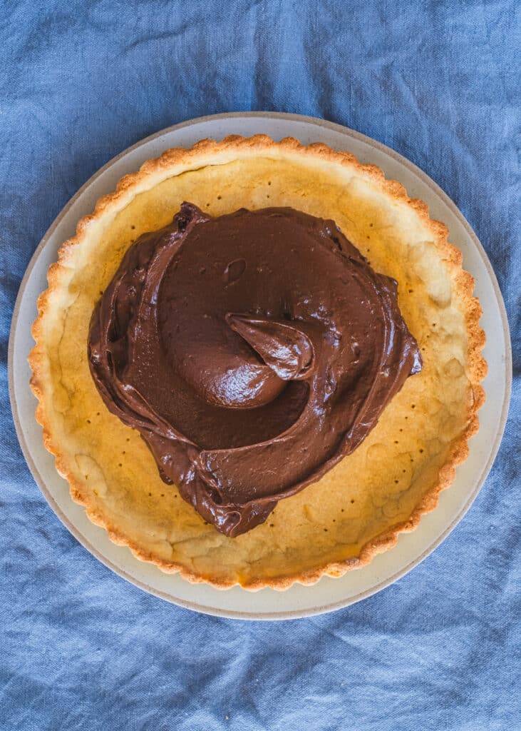 a fully pre baked tart crust with chocolate filling