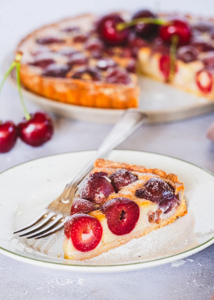 a slice of cherry tart with custard filling