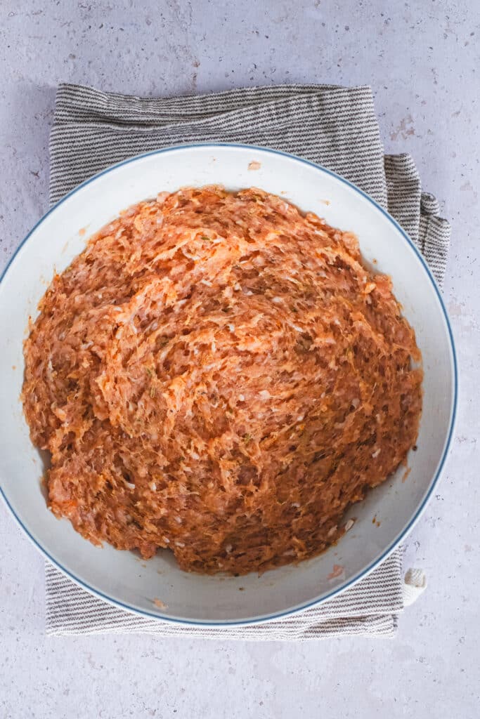 ground chicken and spices mixed in a bowl