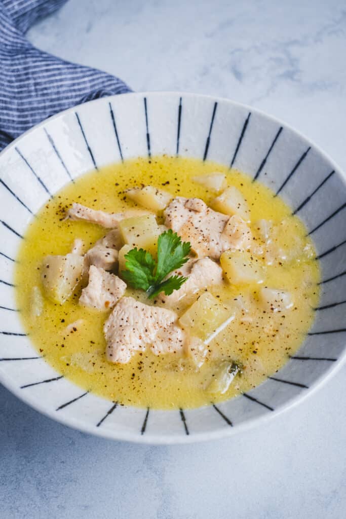 A bowl of kohlrabi chicken soup with lemongrass and ginger